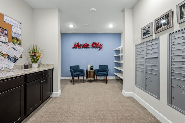 living area with a mail area and light carpet