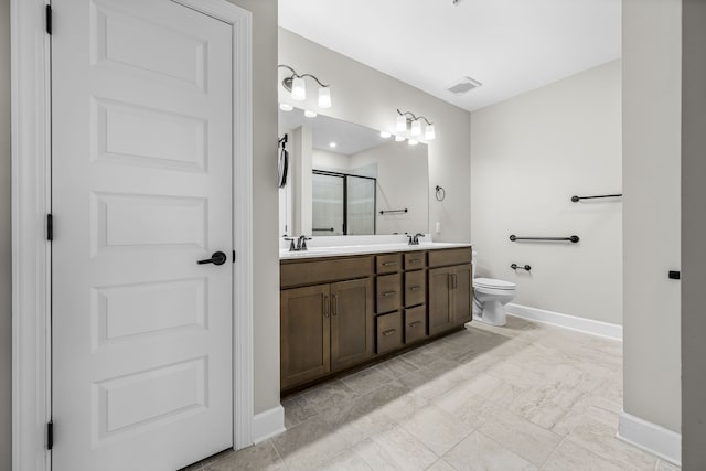 bathroom with vanity, toilet, and an enclosed shower