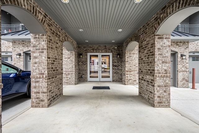 view of patio featuring a balcony and french doors