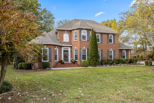 colonial home with a front lawn