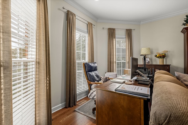 office space featuring hardwood / wood-style flooring, a healthy amount of sunlight, and crown molding