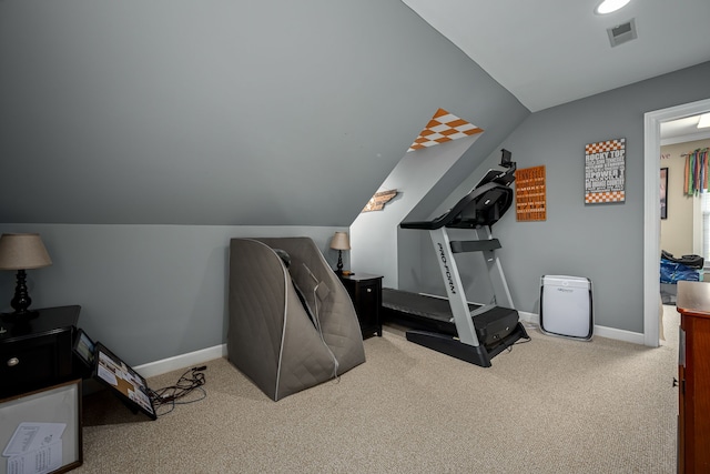 workout room with vaulted ceiling and light colored carpet