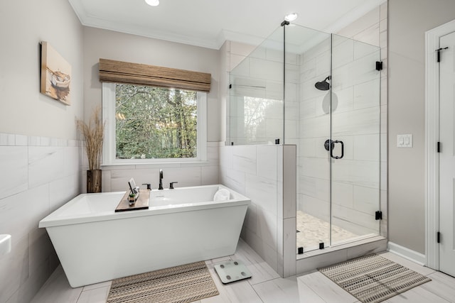 bathroom featuring separate shower and tub, tile walls, and crown molding