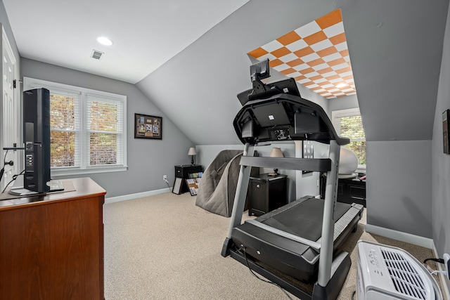 workout area with light carpet and vaulted ceiling