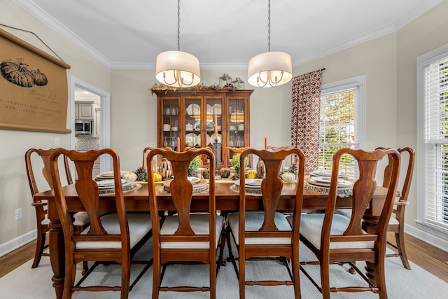 dining room featuring wood-type flooring and ornamental molding