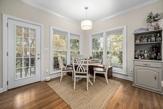 dining space featuring ornamental molding, dark hardwood / wood-style floors, and indoor bar