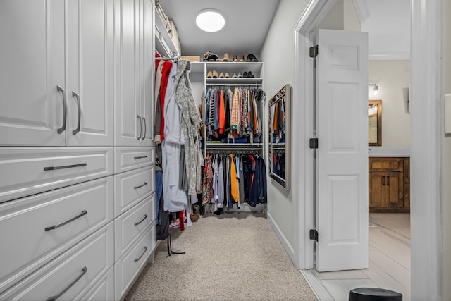 spacious closet featuring light carpet