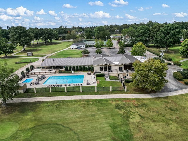 view of pool featuring a patio and a yard