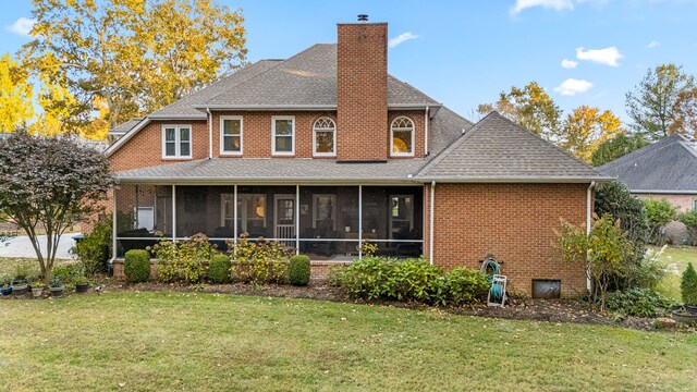 back of house featuring a sunroom and a yard