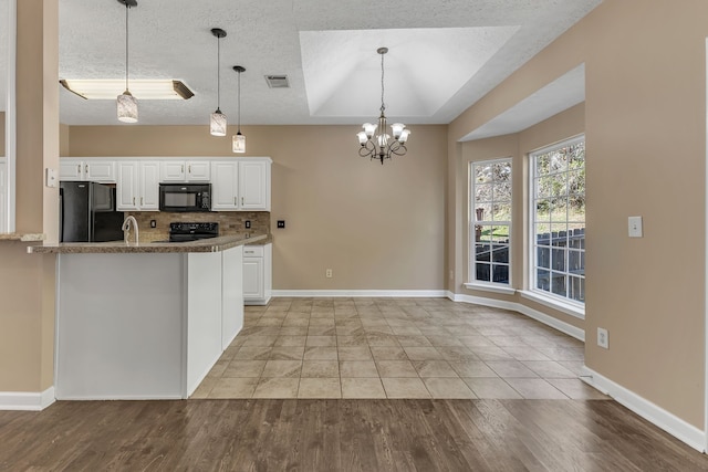 kitchen featuring white cabinetry, black appliances, kitchen peninsula, light hardwood / wood-style flooring, and pendant lighting