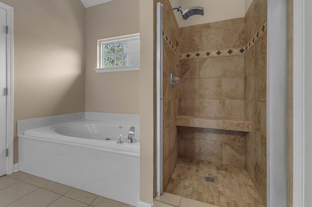 bathroom with shower with separate bathtub and tile patterned floors