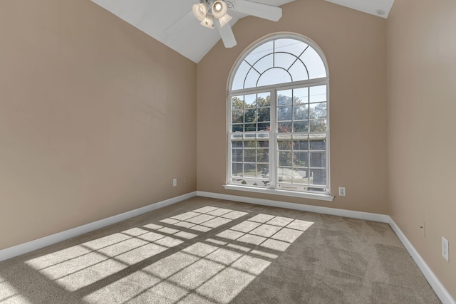 spare room featuring lofted ceiling, carpet flooring, and ceiling fan