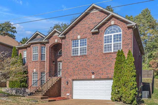 view of property featuring a garage and central AC