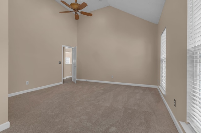 unfurnished room featuring high vaulted ceiling, light colored carpet, and ceiling fan