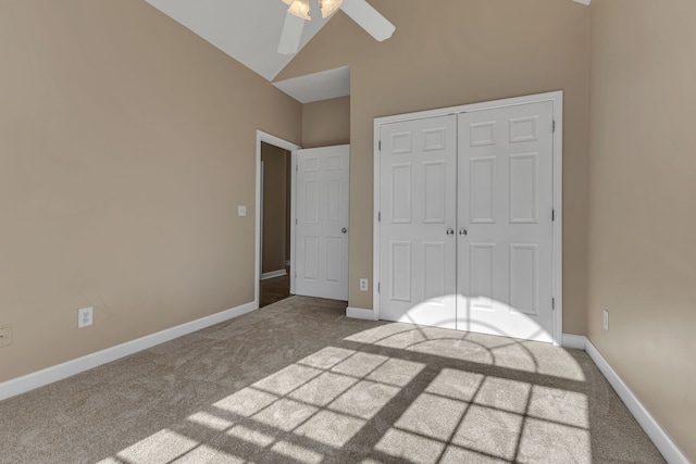 unfurnished bedroom with ceiling fan, carpet flooring, a closet, and lofted ceiling