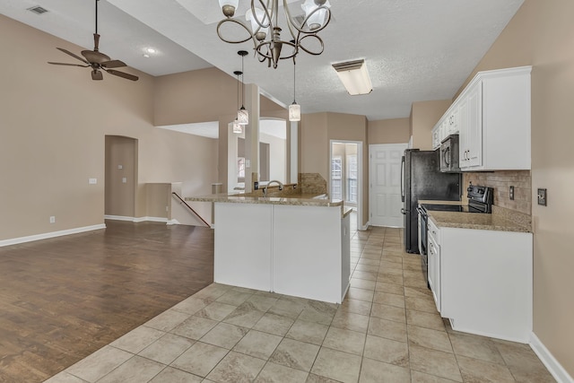 kitchen featuring light hardwood / wood-style floors, a textured ceiling, decorative light fixtures, white cabinets, and black range with electric stovetop