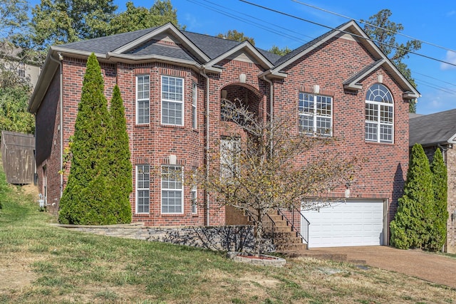 view of front of house featuring a front lawn and a garage