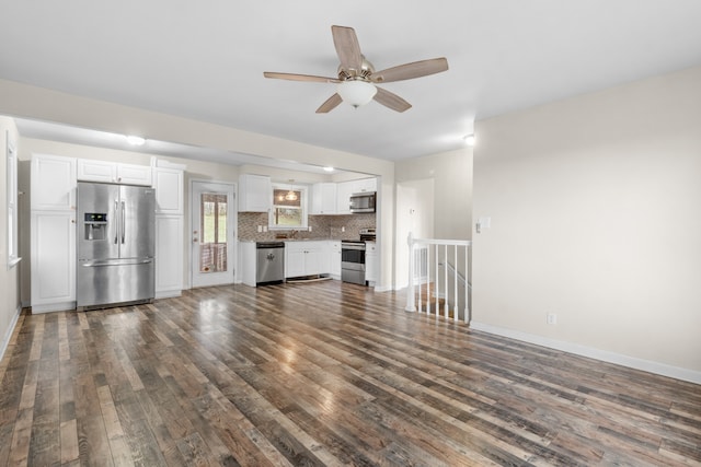 unfurnished living room with ceiling fan and dark hardwood / wood-style flooring