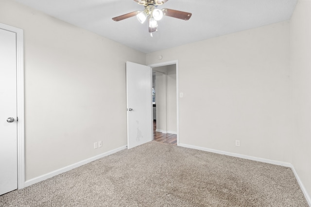 unfurnished room featuring ceiling fan and carpet floors