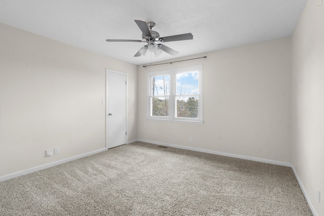 spare room with carpet flooring and ceiling fan