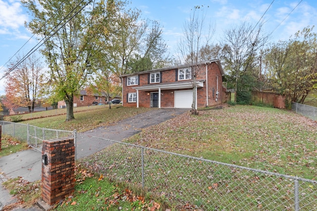 view of front of house featuring a garage and a front lawn