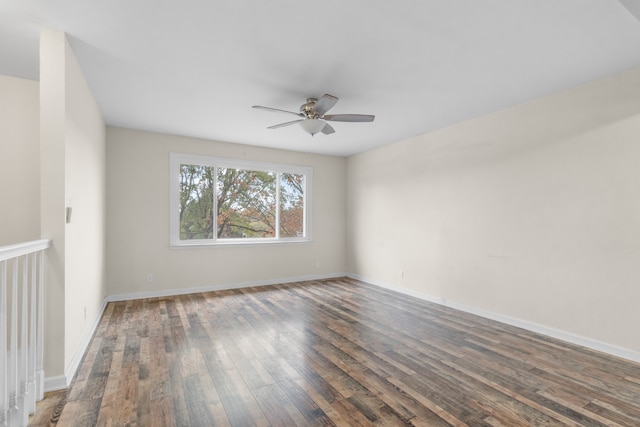 unfurnished room featuring dark wood-type flooring and ceiling fan