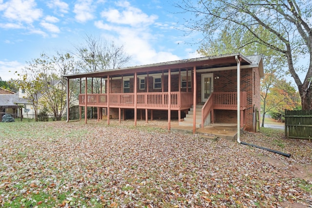 back of property featuring a wooden deck