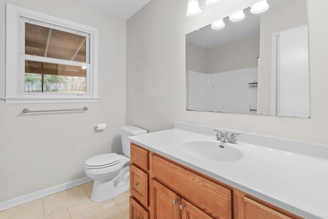 bathroom with vanity, tile patterned flooring, and toilet