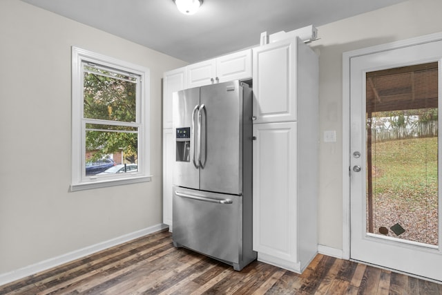 kitchen with white cabinetry, dark wood-type flooring, and stainless steel fridge