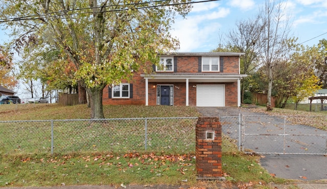 view of property featuring a front lawn and a garage