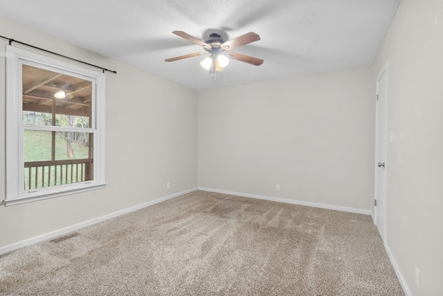 unfurnished room with ceiling fan and carpet flooring