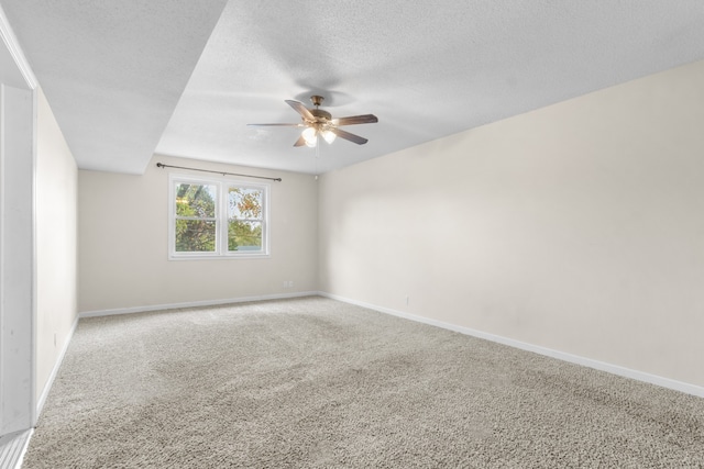 empty room featuring carpet, a textured ceiling, and ceiling fan