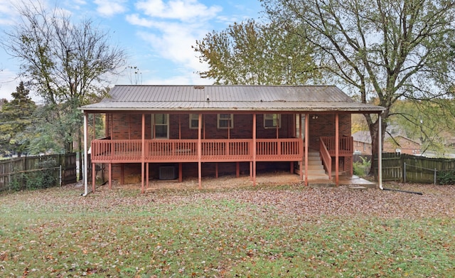 back of house with a lawn and a wooden deck