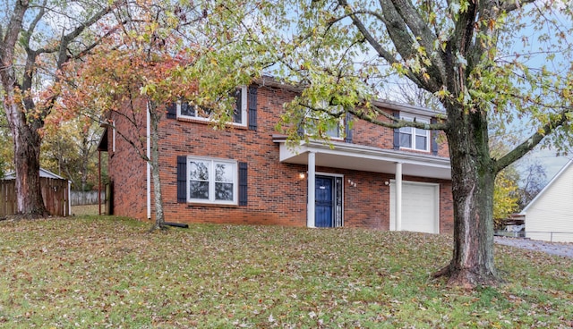 view of front of home with a garage and a front lawn