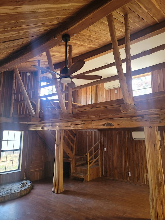 unfinished attic featuring a wealth of natural light and a wall mounted air conditioner