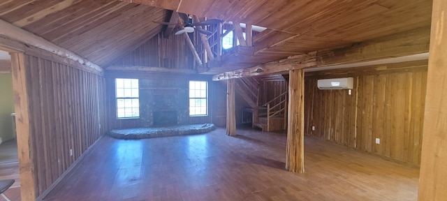 interior space featuring wood ceiling, hardwood / wood-style floors, wooden walls, ceiling fan, and an AC wall unit