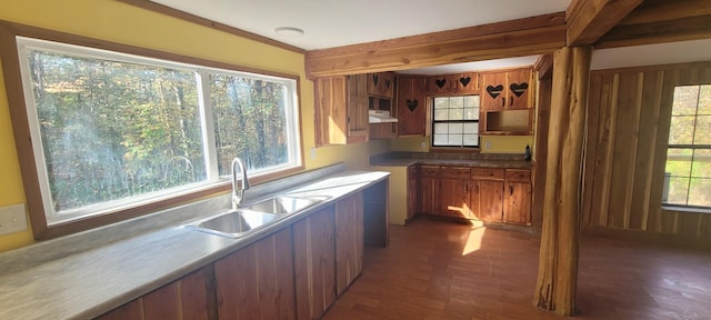 180 Mount View Estates Ln, Holladay, TN 38341 - kitchen featuring under cabinet range hood, brown cabinets, beamed ceiling, and dark wood-style floors