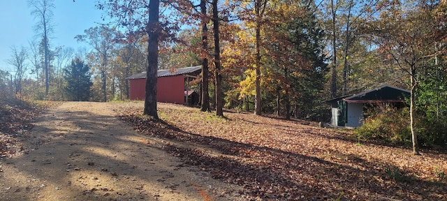 180 Mount View Estates Ln, Holladay, TN 38341 - view of yard with a view of trees, an outbuilding, and dirt driveway