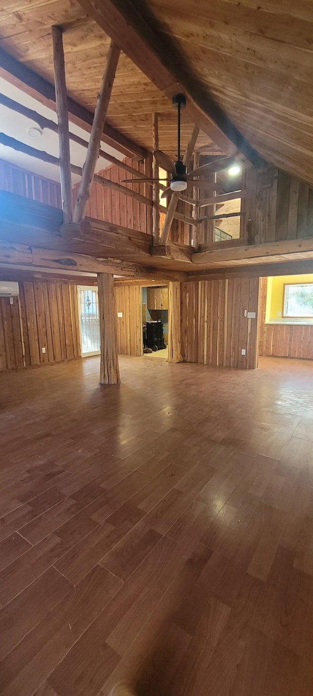 180 Mount View Estates Ln, Holladay, TN 38341 - unfurnished living room featuring ceiling fan, wood walls, hardwood / wood-style floors, high vaulted ceiling, and a fireplace