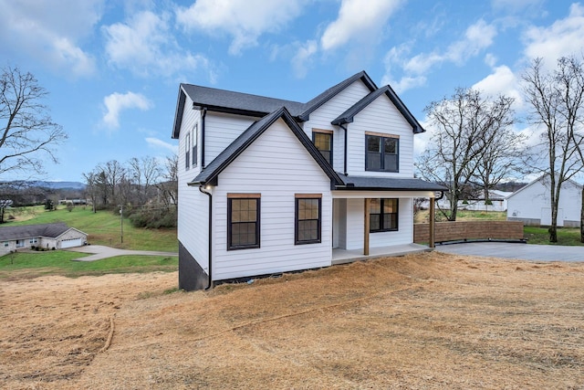 modern inspired farmhouse featuring covered porch