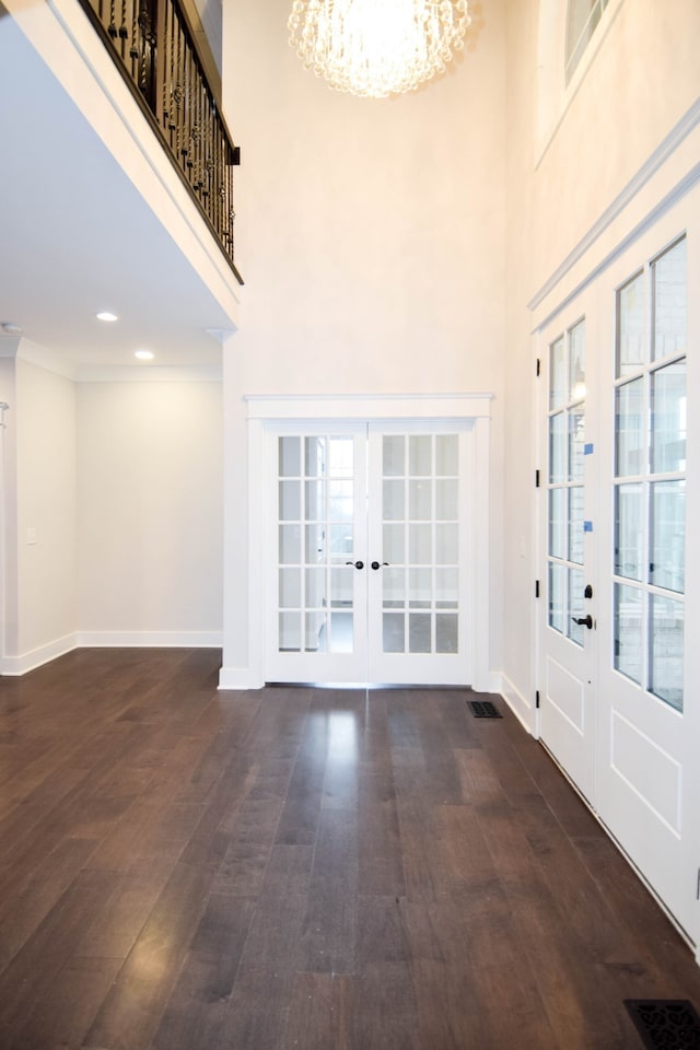 entryway featuring french doors, visible vents, a notable chandelier, and dark wood-style flooring