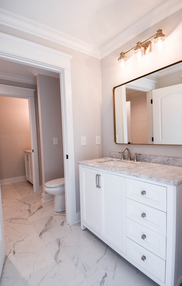 bathroom featuring baseboards, toilet, ornamental molding, marble finish floor, and vanity