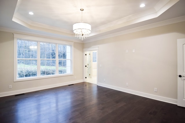 unfurnished room featuring baseboards, a raised ceiling, and dark wood-style flooring