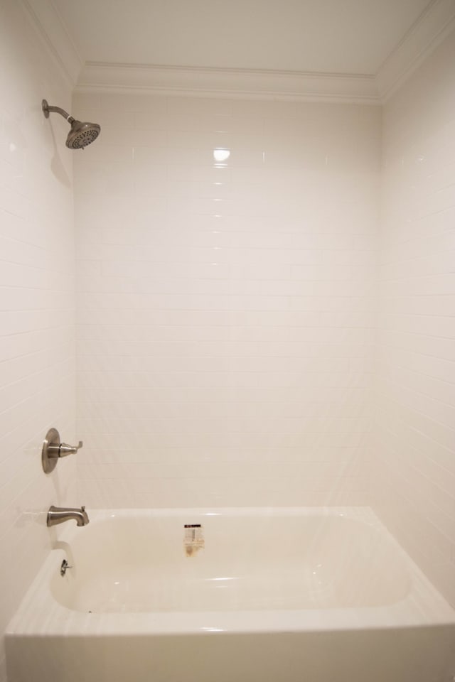 full bath featuring crown molding and bathing tub / shower combination