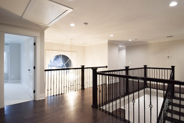 hallway with attic access, baseboards, wood finished floors, an upstairs landing, and recessed lighting