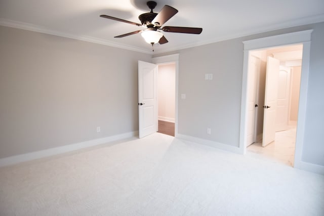 unfurnished bedroom with baseboards, crown molding, and carpet flooring