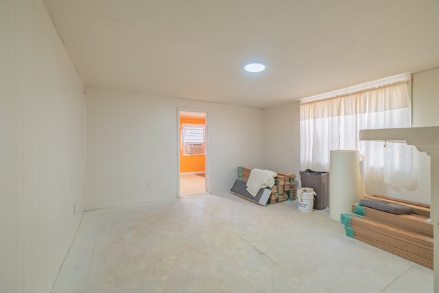 interior space featuring concrete flooring and cooling unit