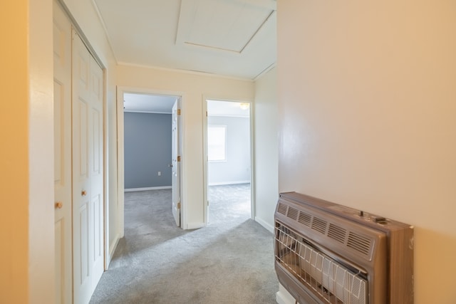 hall featuring ornamental molding, light colored carpet, and heating unit