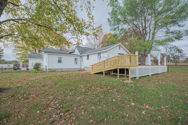 back of house featuring a yard and a deck