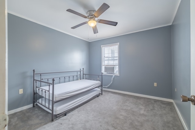 carpeted bedroom with ceiling fan and crown molding